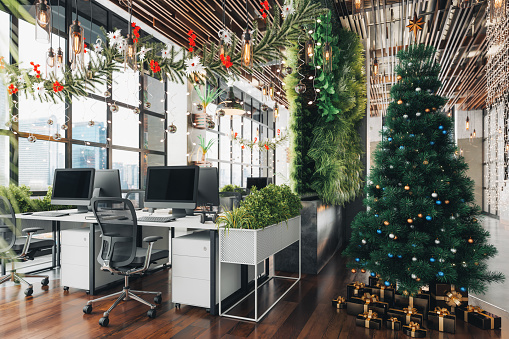 Christmas tree and decorations in a modern office space.