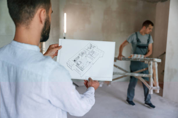 istock Working according to a plan. Two men is making repairs in the apartment together 1438602993