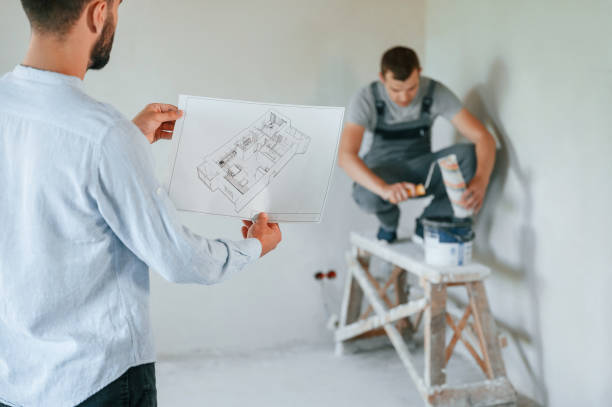istock Working according to a plan. Two men is making repairs in the apartment together 1438603006