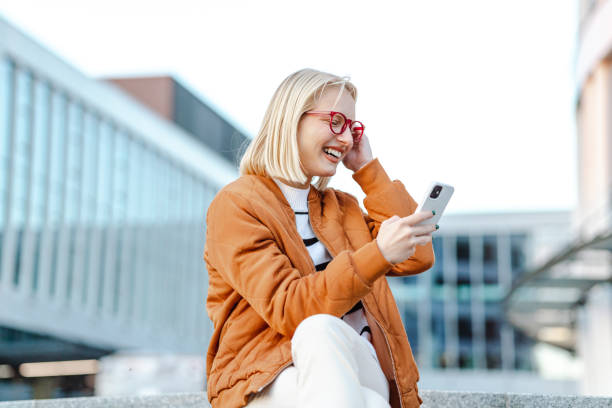 istock Young woman using smart phone in the city 1438603867