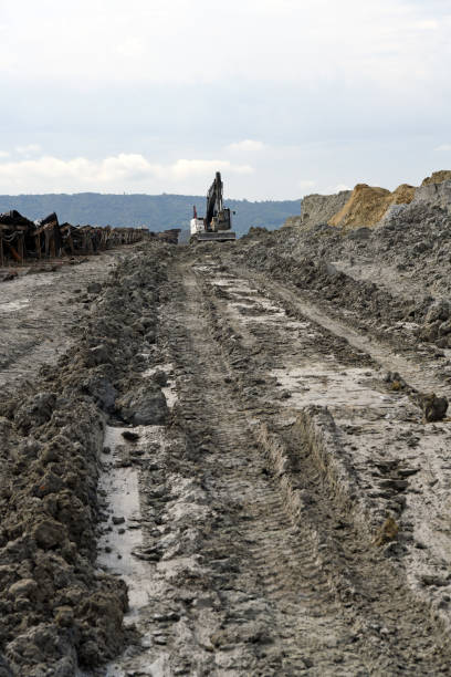 istock A bulldozer during operation on muddy ground in an open pit mine. Conveyor belt on surface coal mine. 1438605262