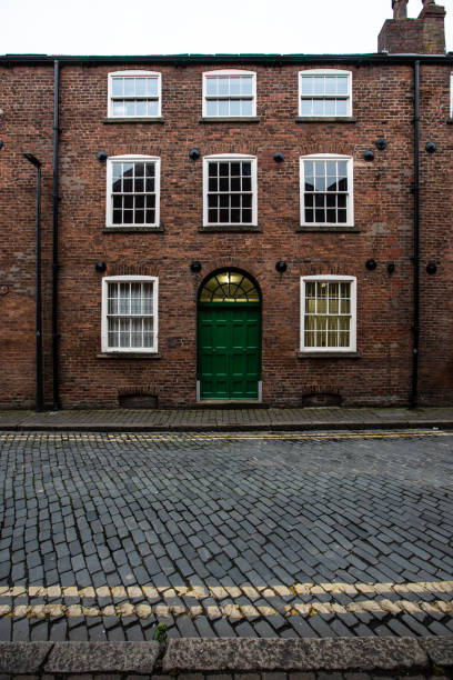 Brewery Wharf, Leeds, UK - September 30, 2022.  An architectural image of an old Victorian terraced house or townhouse on the cobbled street of Brewery Wharf in Leeds.