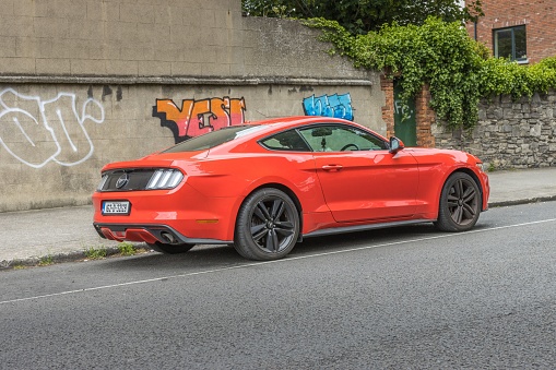 Dublin, Ireland – July 09, 2022: A Ford Mustang parked in near building in Dublin