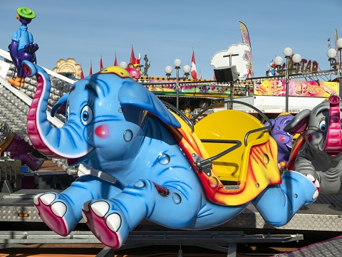 Geneva, Switzerland – January 04, 2020: Running (or flying) elephant  in a carousel