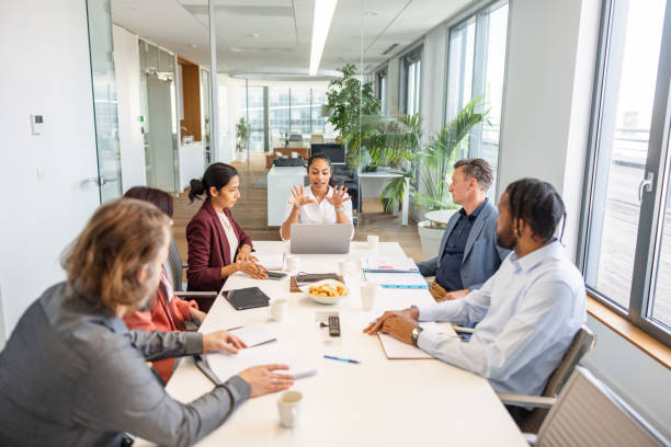 istock Young Dark-Skinned Woman Explaining The New Project Requirements To Her Co-Workers 1438610688