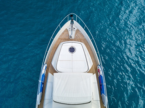 An aerial shot of a yacht sailing on the sea - great fro background or a blog