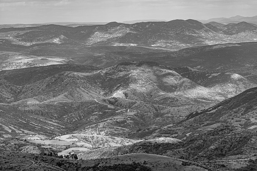 A grayscale shot of hills and mountains