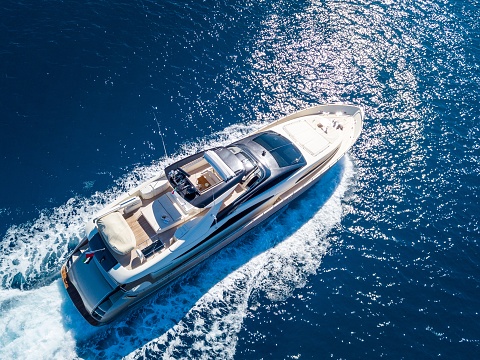 Aerial shot of a yacht sailing on the sea at daytime