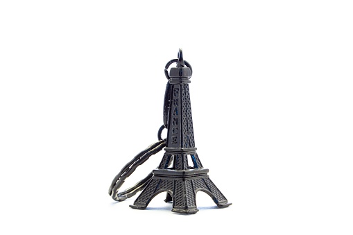 A black Eiffel tower pendant in a white background