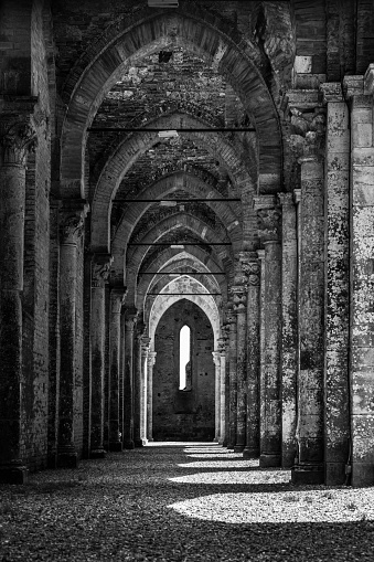 A vertical greyscale shot of famous historic Abbey of Saint Galgano in Tuscany, Italy