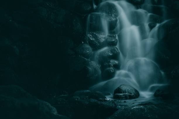 istock Dramatic shot of a waterfall stream over the rocky cliff 1438613305
