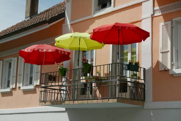 Balcony with red and yellow umbrellas under the clear sky