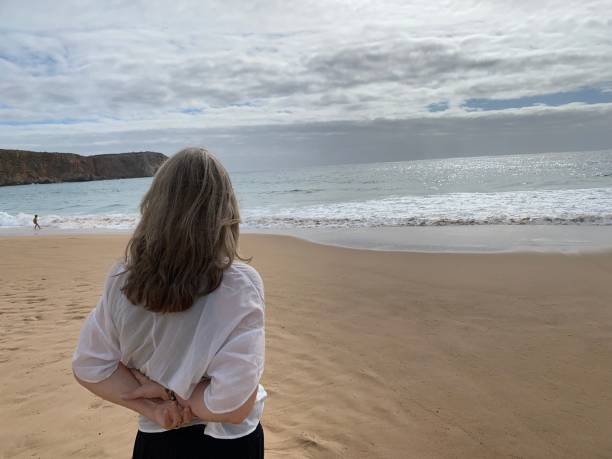 istock Woman watching the coastline 1438613448
