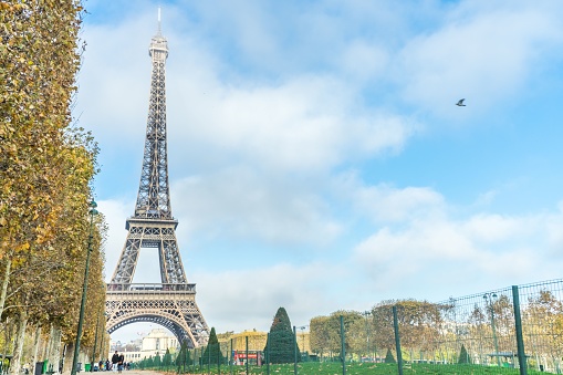 A beautiful shot of the Eiffel Tower under the soft cloudy sky