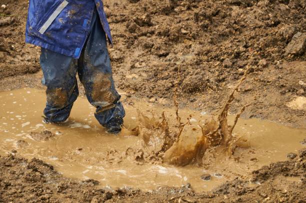 istock Person on muddy ground after the rain 1438614793