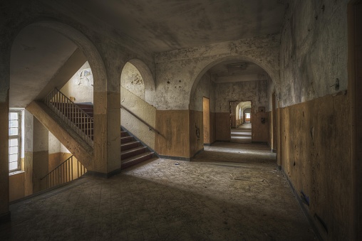 A beautiful shot of a hallway and stairs in an old building