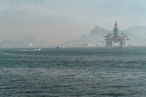 The oil extraction platform in the sea surrounded by hills in Rio de Janeiro in Brazil
