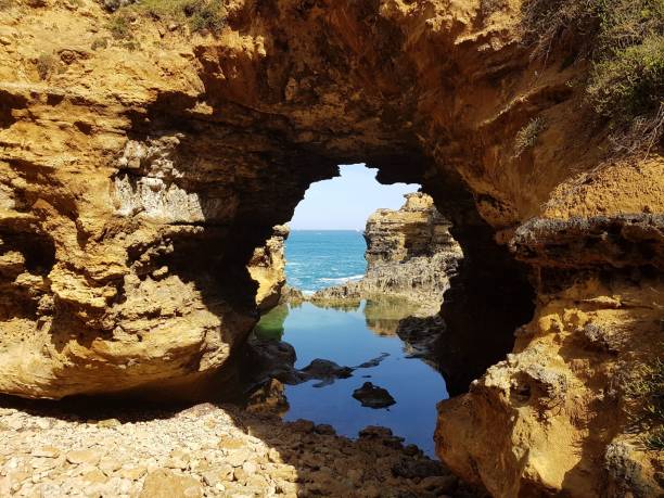 istock Grotto which is is a tourist attraction with ocean and blocks 1438616181