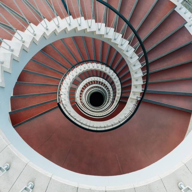 istock High angle view of a modern spiral staircase under the lights 1438616966