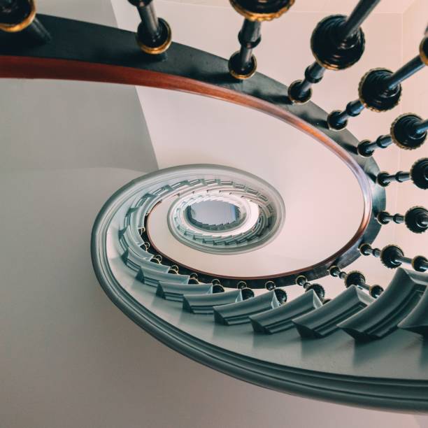 istock High angle view of a modern spiral staircase under the lights 1438616976