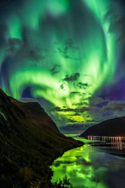 istock Vertical shot of Aurora over the sea and cliffs 1438617123