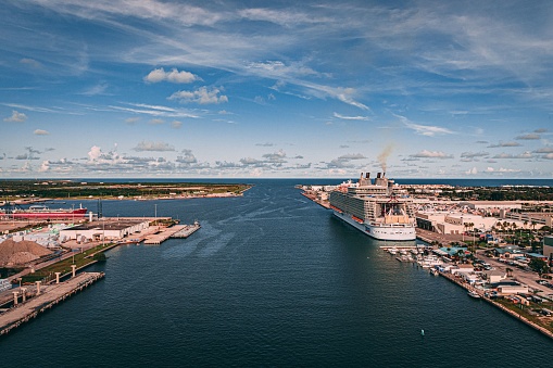 A drone shot of the blue sea and a big ship docked in the port of Cape Canaveral, Florida