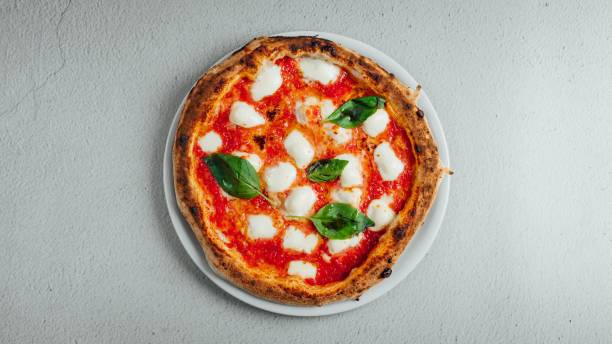 istock Top view of a pizza Margherita on a table 1438618008