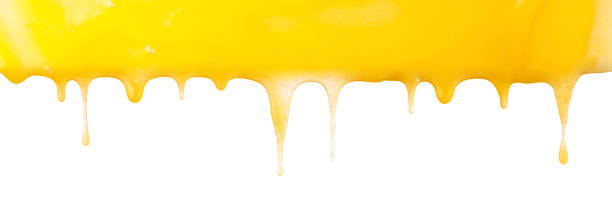 istock Sticky yellow honey dripping on white background, border. 1438619827