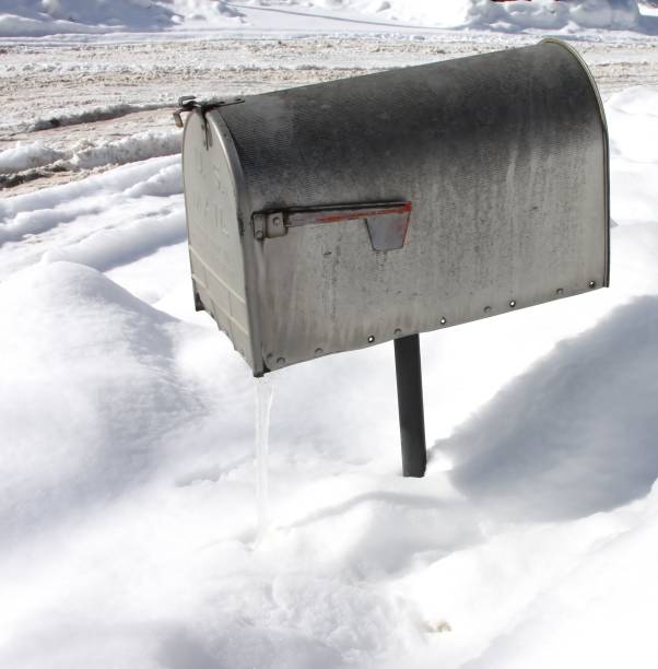 istock Overhead shot of a silver mailbox with snow in the surface during winter 1438620772