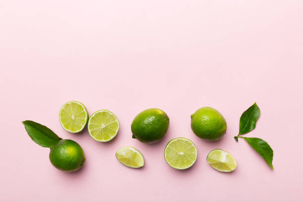 istock Lime fruits with green leaf and cut in half slice isolated on white background. Top view. Flat lay with copy space 1438622466