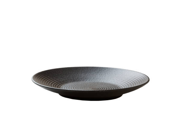 Black ceramic round plate isolated over white background. perspective view