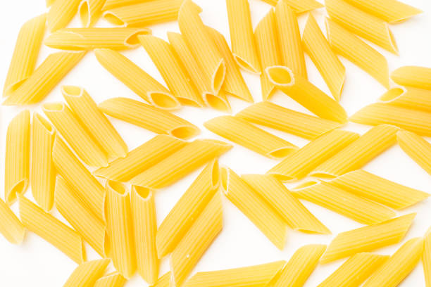 istock Dry penne pasta on a white background 1438624626