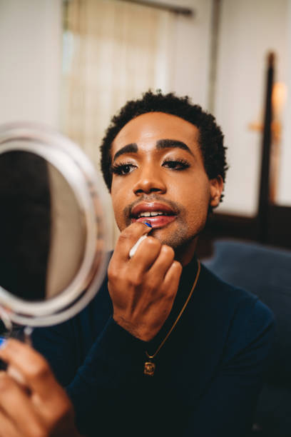 istock Non binary person is putting on makeup up in the bedroom 1438625968