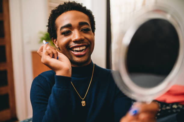 istock Non binary person is putting on makeup up in the bedroom 1438626008