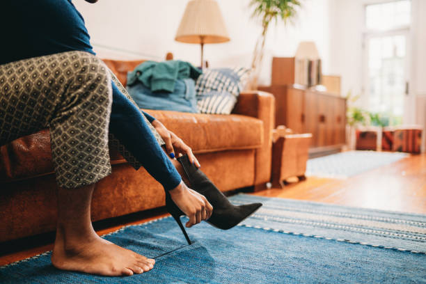 istock A non-binary person is getting dressed, wearing heeled shoes 1438626643
