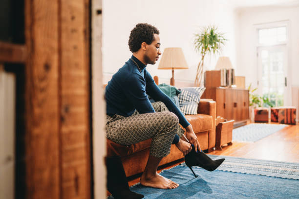 istock A non-binary person is getting dressed, wearing heeled shoes 1438626689