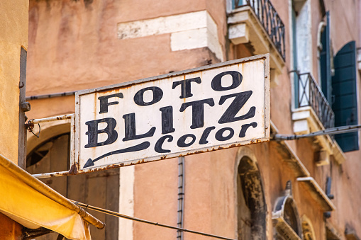 Venice, Italy - October 6th 2022: Old advertisement sign for a camera shop in the center of the old and famous Italian city Venice