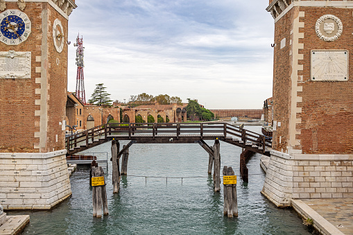Venice, Italy - October 10th 2022: Wooden bridge over a canal connecting two buildings which are parts of the Arenale, a old fortification in the center of the old and famous Italian city Venice