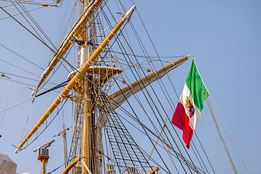 Venice, Italy - October 6th 2022:  Flag in the rigging of the Amerigo Vespucci school ship in the harbor in the center of the old and famous Italian city Venice