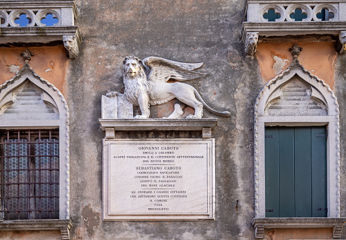Venice, Italy - October 9th 2022:  The lion of St. Mark is a symbol of the city Venice. This is an old relief on a façade of a palace in the center of the old and famous Italian city Venice