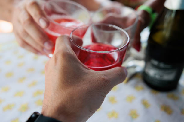istock hands of three unrecognizable caucasian persons celebrating an event by toasting their glasses, full of various non  alcolohlic and alcoholic drinks 1438630090