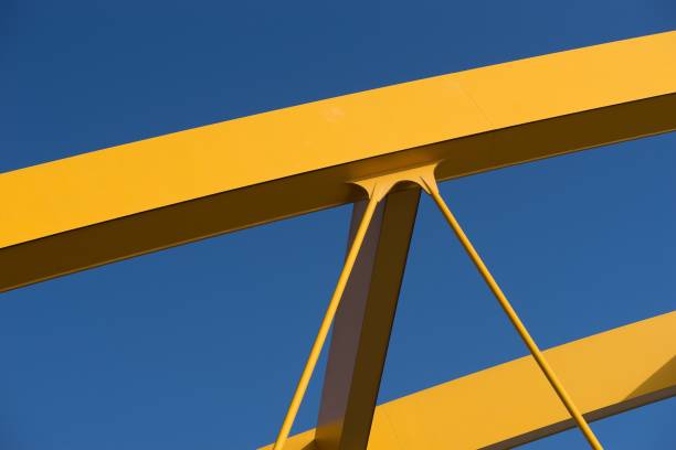 istock Fragments of a modern yellow construction with a blue background 1438630118