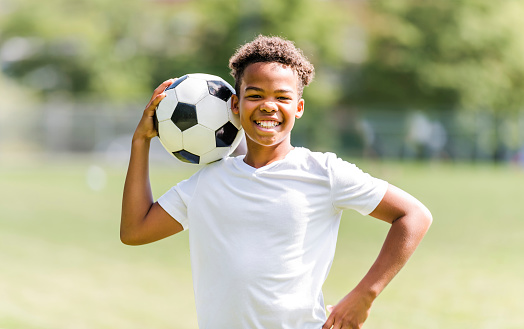 A happy multicultural hispanic soccer player outdoor in sunny day