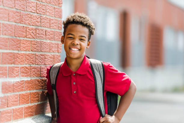 istock Smiling african american school boy with backpack 1438631155