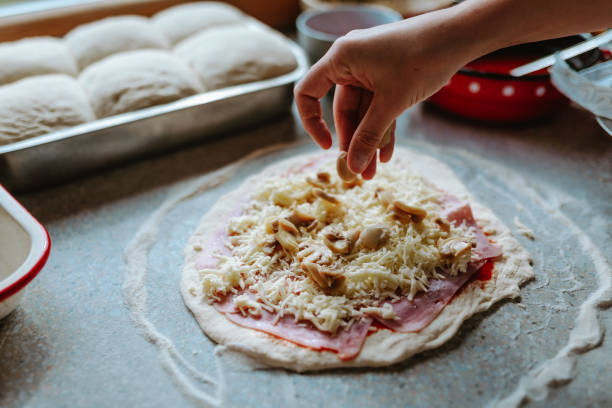 istock Woman making original italian pizza at home 1438634445