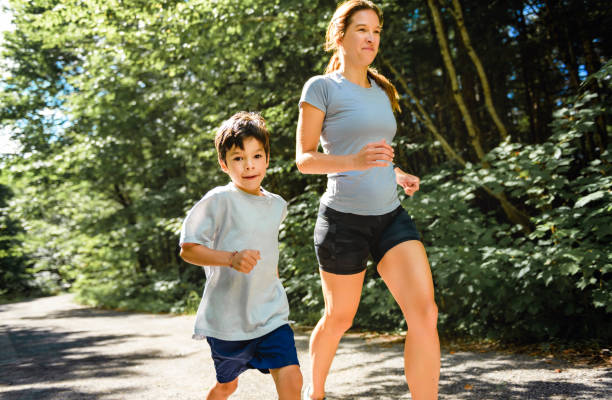 istock mother and son running outside in forest 1438635324
