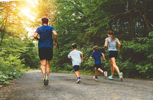 A Family exercising and jogging together at an outdoor park