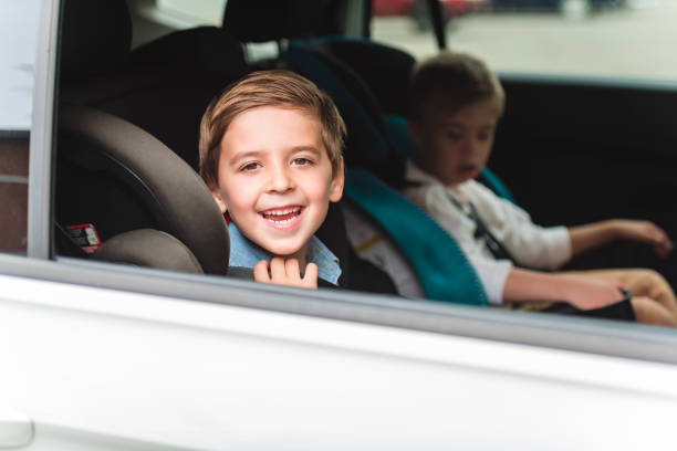 istock cute boy sitting in safety car seat 1438638925
