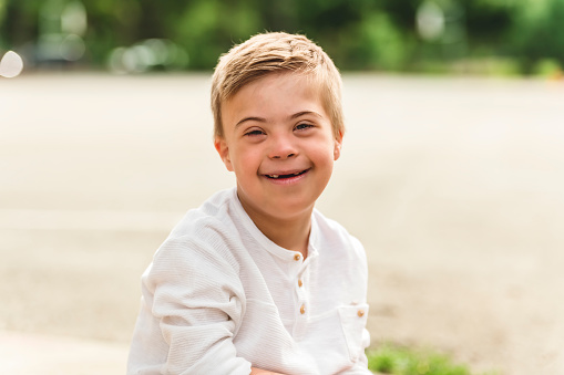 A Portrait of a little schoolboy with down syndrome