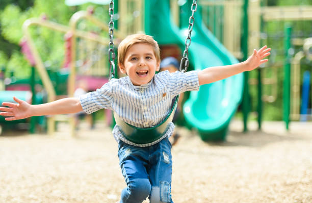 istock Baby boy having fun on a swing. 1438639019